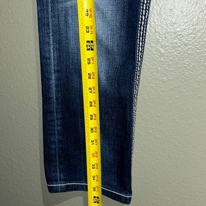 Rock revival,modern style tears at the knees and faded scratches Size 30